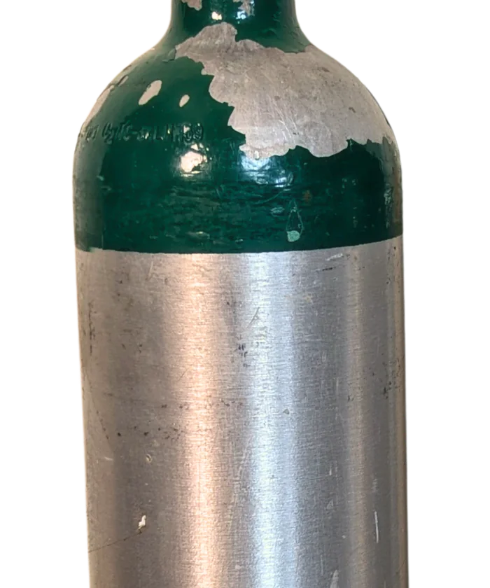 The same cylinder before refurbishment: the crown coating is chipped back to bare metal and the body is scuffed